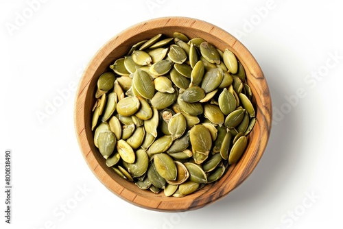 Close up photo of roasted and salted pepita seeds in wooden bowl a snack made from Cucurbita pepo seeds White background