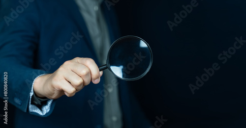 Photography Business people holding magnifying glass on concept of finding something with blank space for copy space