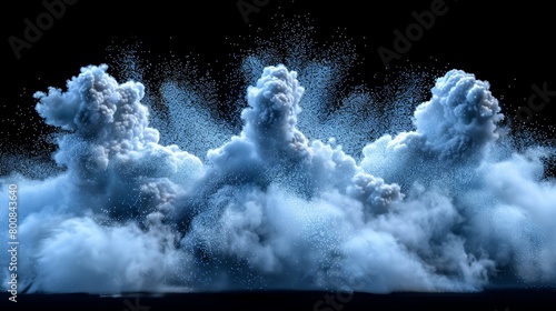   A cluster of clouds in the sky emitting copious white vapor from their summits photo
