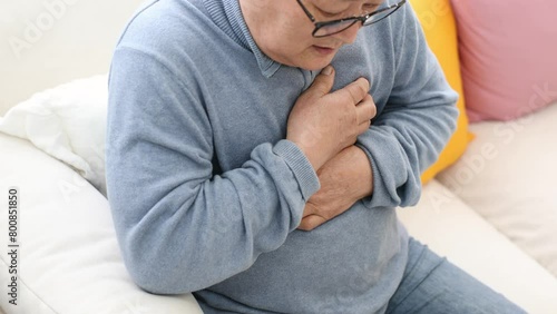 Elderly person complaining of chest pain photo