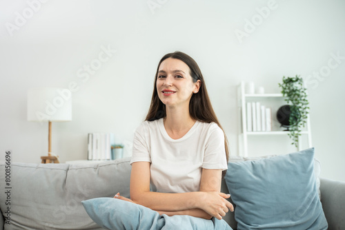 Portrait of young Caucasian woman sit on sofa in living room at home. 