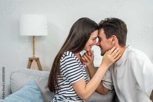 Caucasian young couple spend free leisure time together in living room. 