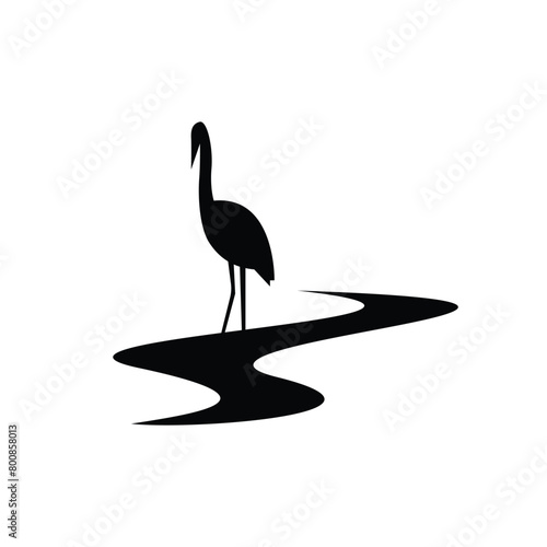 Black and white silhouette of heron bird on a creek stream
