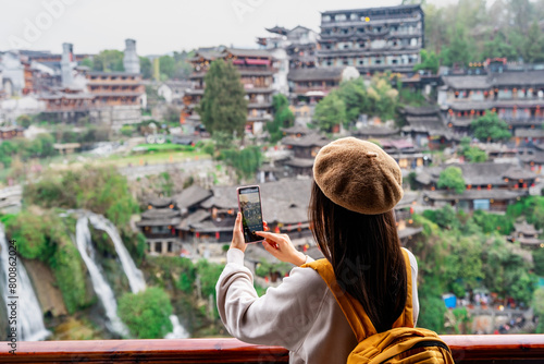 Young female tourist enjoying beautiful landscape at the Furong old Town, The famous tourist destination at Hunan Province, China © Kittiphan