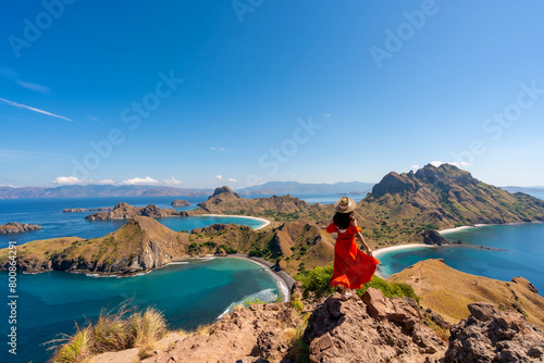 Young female tourist enjoying the beautiful landscape at Padar island in Komodo National Park, Indonesia © Kittiphan