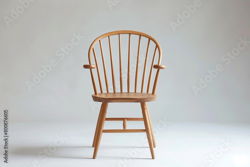 A modern twist on a Windsor chair showcased against a solid white backdrop, isolated on solid white background.