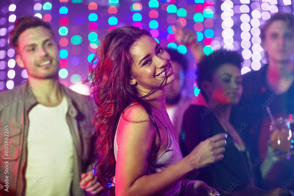 Portrait, dancing and woman, nightclub and party with friends, smile and celebration for birthday, confidence and fun. Bokeh, group and lights for new year, weekend and countdown in rave with energy