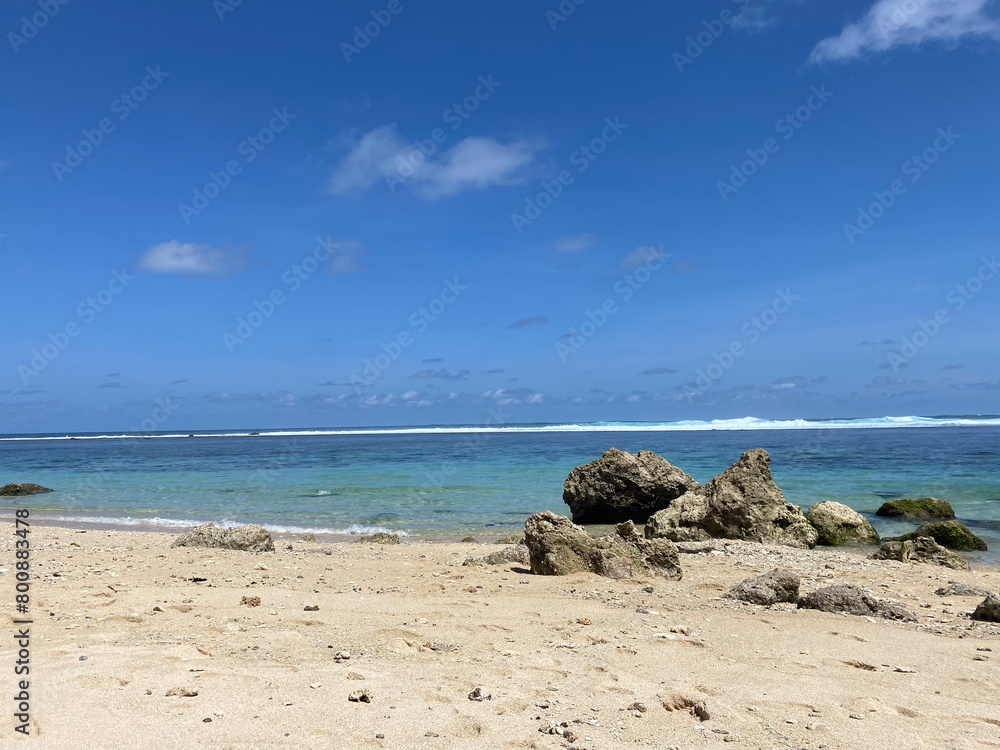beautiful Bali beach with rocks and a blue sky beautiful Bali beach with rocks and a blue sky