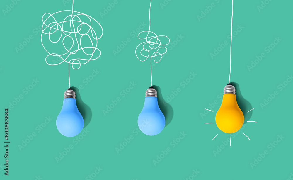 Clarifying complex ideas through the glow of lightbulbs - Flat lay Clarifying complex ideas through the glow of lightbulbs - Flat lay
