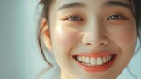 Close-up of smiling young woman with healthy white teeth. Dental care concept.