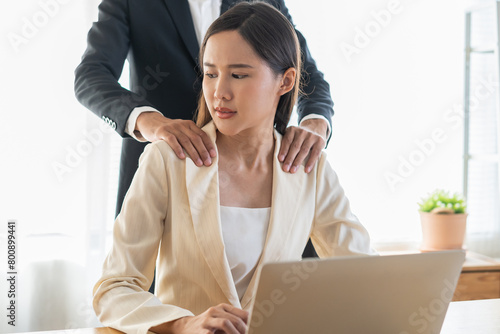 Photography Disgusted asian young employee, pressure business woman uncomfortable, looking hand of boss or colleague  male when touching her shoulder, embrace