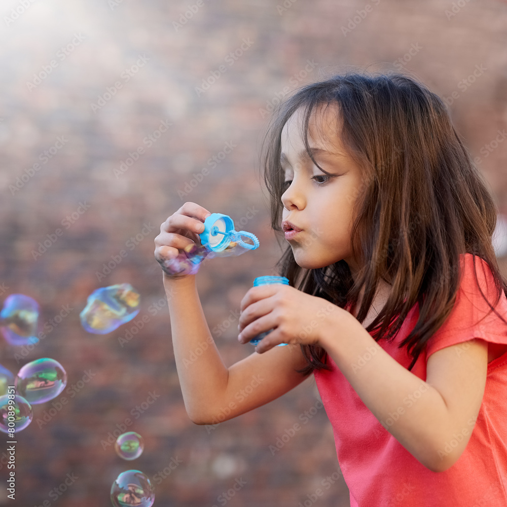Blowing, bubbles and girl outdoor relax in summer with magic, toys or fun on vacation or holiday. Childhood, memory and child with breathe in foam or soap in backyard, garden or park with peace Blowing, bubbles and girl outdoor relax in summer with magic, toys or fun on vacation or holiday. Childhood, memory and child with breathe in foam or soap in backyard, garden or park with peace