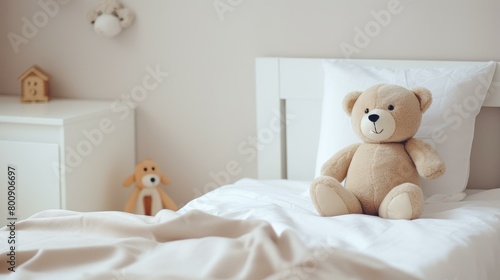 A cute teddy bear sits on a bed in a child's bedroom