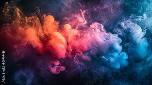 Colorful smoke flowing on a dark background photo