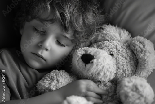 Young child sleeping peacefully with a teddy bear