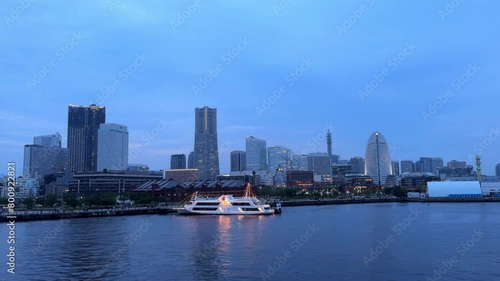 Twilight cityscape with a yacht on the water, skyline illuminated, tranquil urban scene, dusk Twilight cityscape with a yacht on the water, skyline illuminated, tranquil urban scene, dusk