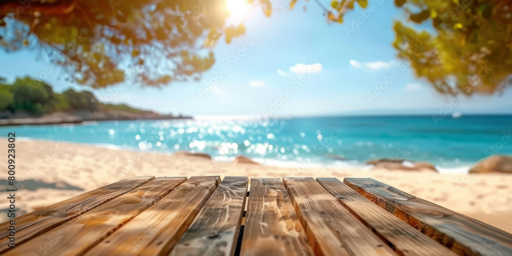 Fototapeta premium Empty wooden table top with blurred beach background for product display, vacation and travel concept. summer banner template.
