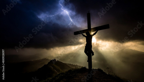silueta de jesús en la cruz al caer el sol photo