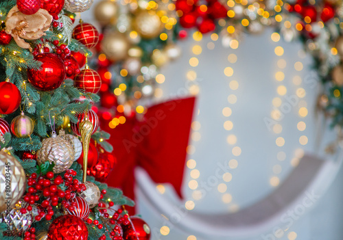 A Christmas tree decorated for the new year with toys and bows on a festive background. An elongated panoramic image for a banner in red and white colors
