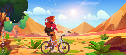 Female tourist with bicycle looking at sandy dunes. Vector cartoon illustration of young woman cycling, looking at sandy summer desert, green trees and grass, stones on ground, bright sun in blue sky © klyaksun