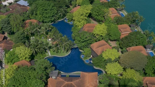 Slow motion landscape view of swimming pools and resort villa buildings in Adventure Cove Waterpark on Sentosa Island Singapore city Asia photo