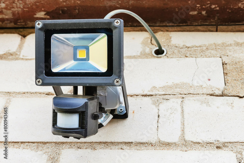 The LED motion sensor lamp is attached to the outer masonry wall