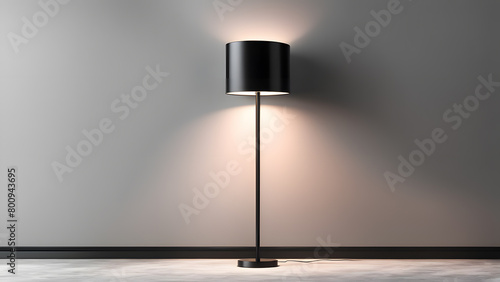 A black lamp is standing in front of a grey wall photo