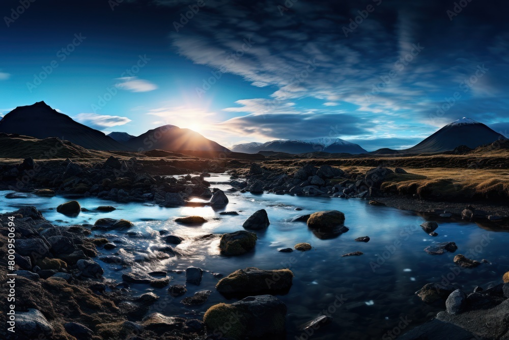 Serene mountain landscape with a stream and sunset