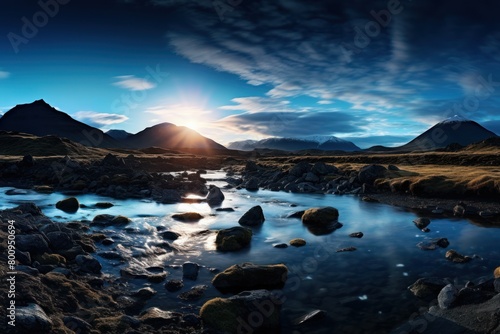 Serene mountain landscape with a stream and sunset