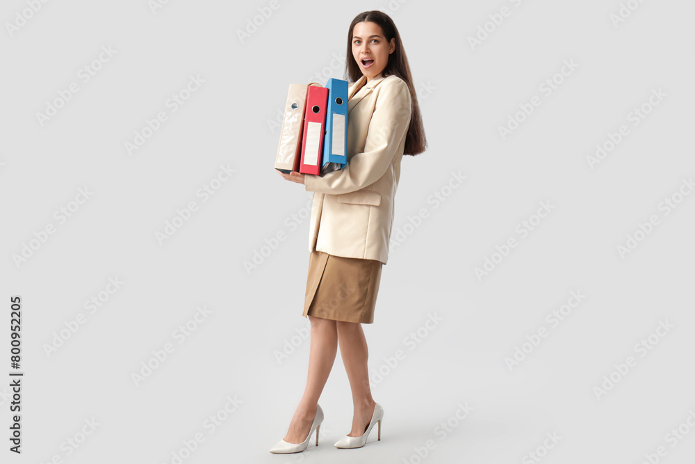 Shocked businesswoman with folders on white background Shocked businesswoman with folders on white background