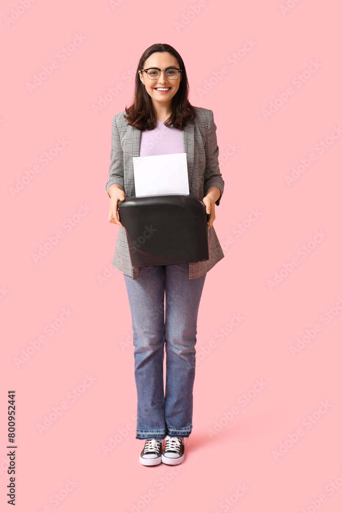 Fototapeta premium Secretary with shredder on pink background