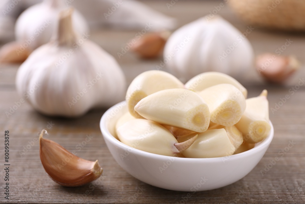 Aromatic garlic cloves and bulbs on wooden table, closeup. Space for text Aromatic garlic cloves and bulbs on wooden table, closeup. Space for text