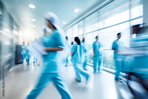 Medicals and doctors walk down a hospital corridor. Blurred motion 