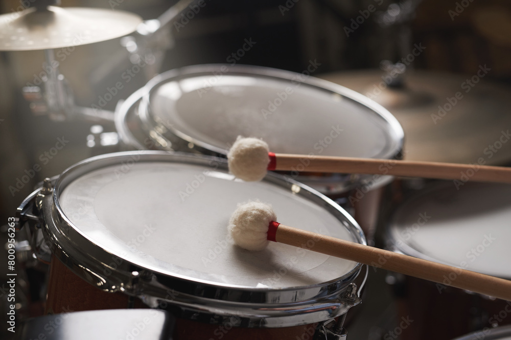 Drum, kit and performance of music on instrument for concert with creativity and talent. Stage, drums and drumsticks for drummer in rock band to play rehearsal of festival or musical event in theatre Drum, kit and performance of music on instrument for concert with creativity and talent. Stage, drums and drumsticks for drummer in rock band to play rehearsal of festival or musical event in theatre