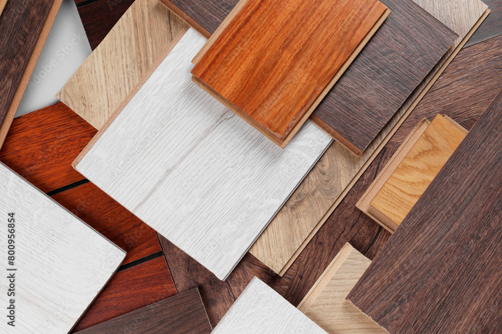 Different samples of wooden flooring as background, flat lay