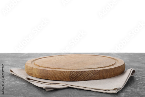 Wooden cutting board and napkin on grey table