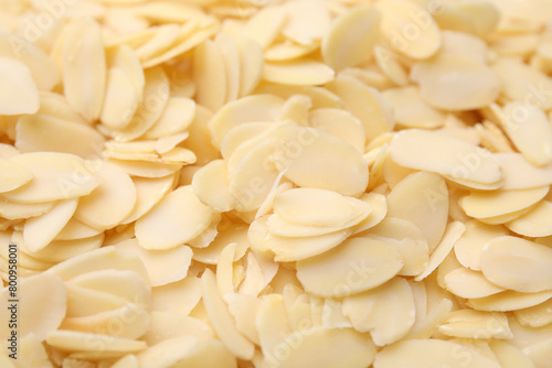 Fresh almond flakes as background  above view
