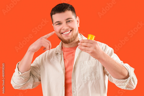 Young man with eye drops an...