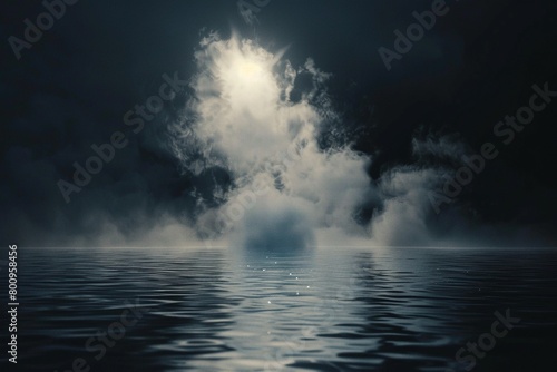 Black and white photo: Ethereal clouds and mist, suggestive of a holy presence, dance above the darkness of a mysterious body of water.