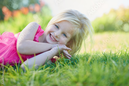 Portrait, smile and girl child on grass in field or nature for summer holiday or vacation. Garden, park and smile with happy young kid outdoor for development, growth or peace on green lawn