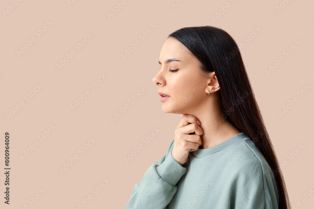Beautiful young woman suffering from sore throat on brown background Beautiful young woman suffering from sore throat on brown background