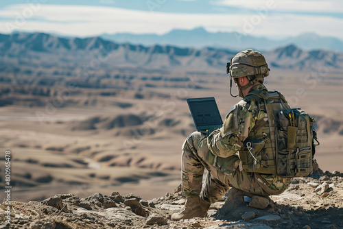 photo surrounded by the vastness of the desert, a soldier engages in tactical communication using a laptop computer and radio equipment, essential tools for success in the midst of