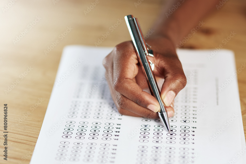 Hand, pen and person with answer sheet for university test, assignment or exam in classroom. Education, table and student writing on paper for quiz, assessment or form at college campus for education Hand, pen and person with answer sheet for university test, assignment or exam in classroom. Education, table and student writing on paper for quiz, assessment or form at college campus for education