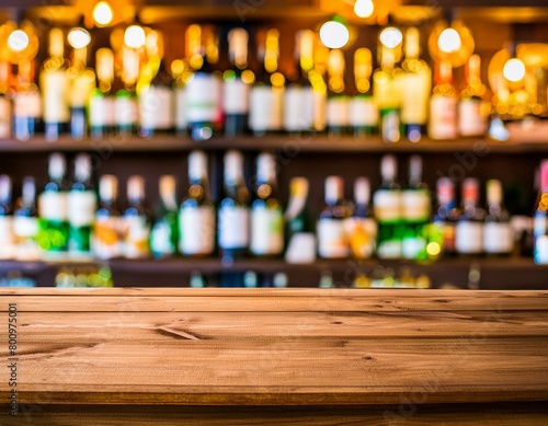 Wooden board and beautiful bokeh shelves with alcohol bottles at the background