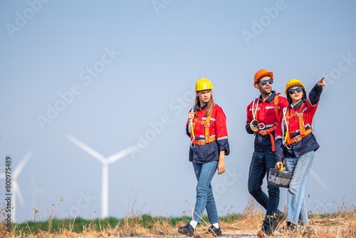 engineer team inspection check control wind power machine construction installation in wind energy factory. technician professional worker discussion check for maintenance electronic wind turbine photo