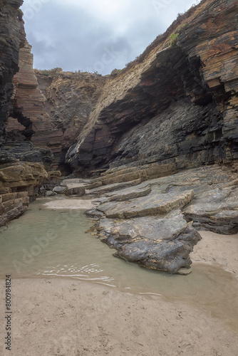 Cathedrals beach (Playa de las Catedrales) or Praia de Augas Santas at low tide, bizarre natural rocks and caves, tourist attraction in Ribadeo, Galicia, Spain. Outdoor travel background photo