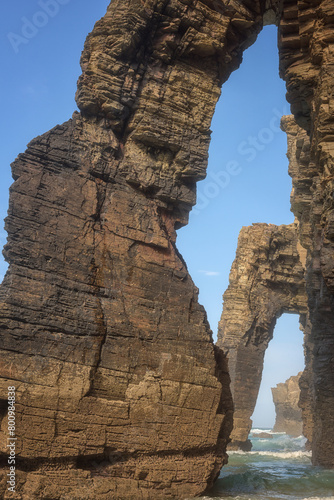Cathedrals beach (Playa de las Catedrales) or Praia de Augas Santas at low tide, bizarre natural rocks and caves, tourist attraction in Ribadeo, Galicia, Spain. Outdoor travel background photo