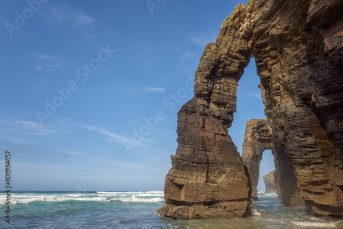 Cathedrals beach (Playa de las Catedrales) or Praia de Augas Santas at low tide, bizarre natural rocks and caves, tourist attraction in Ribadeo, Galicia, Spain. Outdoor travel background