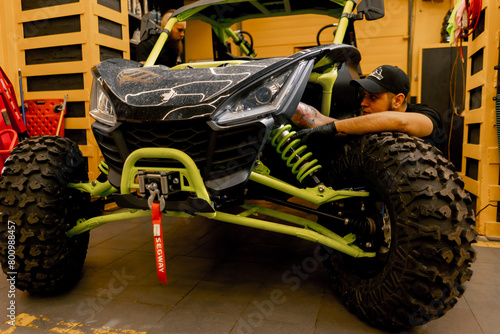 Bild auf Leinwand In a motorcycle repair shop a mechanic checks the brakes of an ATV extreme ridin
