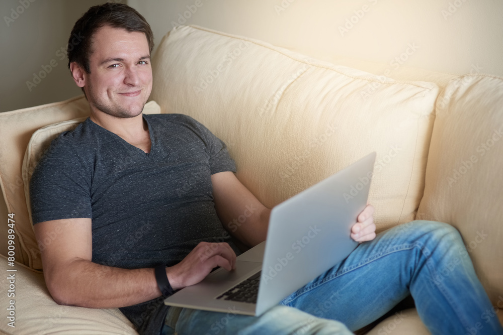 Man, portrait and smile on sofa with laptop for relax, research and reading in living room of home. Person, computer and happy for communication, networking on internet and streaming on couch Man, portrait and smile on sofa with laptop for relax, research and reading in living room of home. Person, computer and happy for communication, networking on internet and streaming on couch